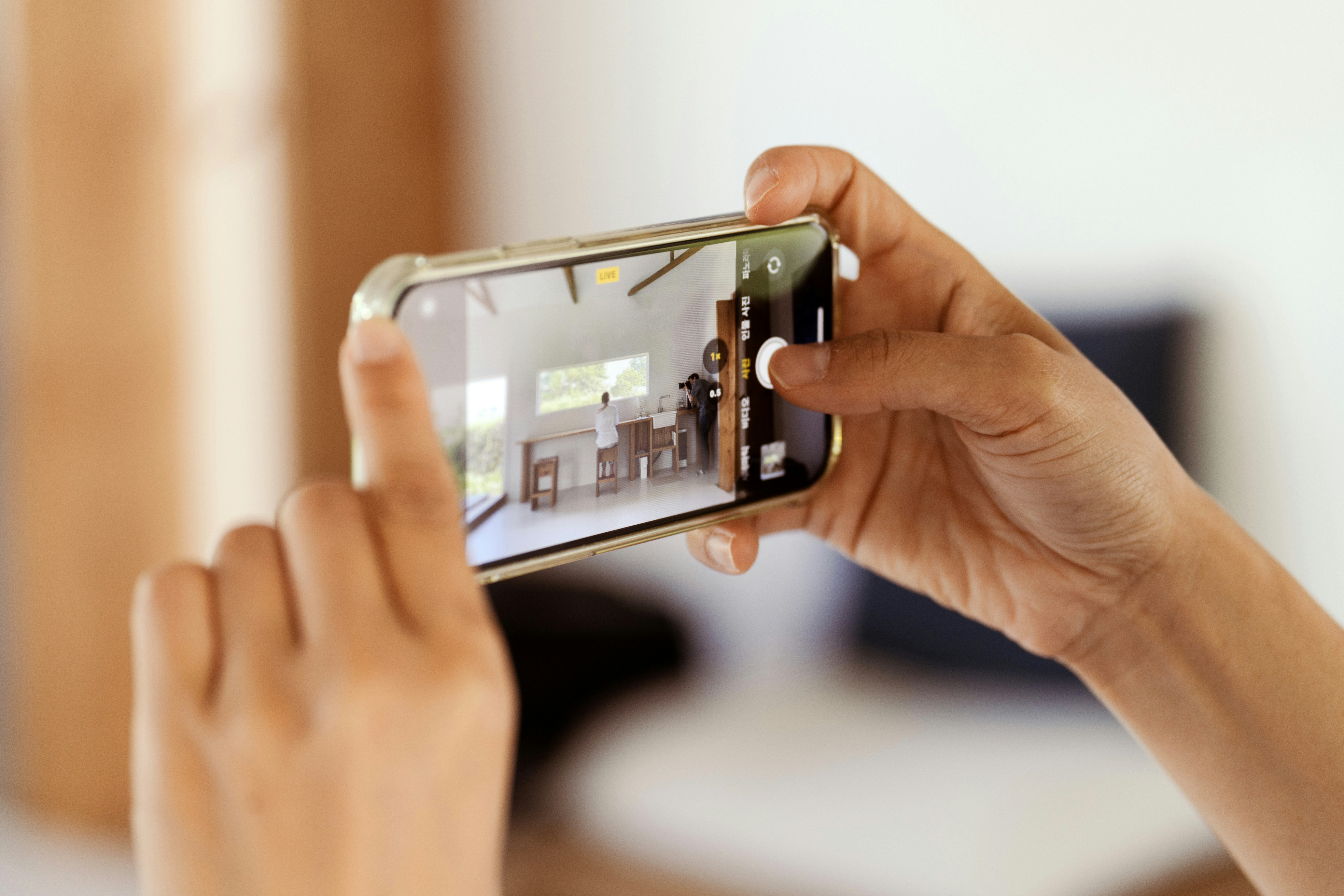 Homeowner taking a photo of their home with a smartphone